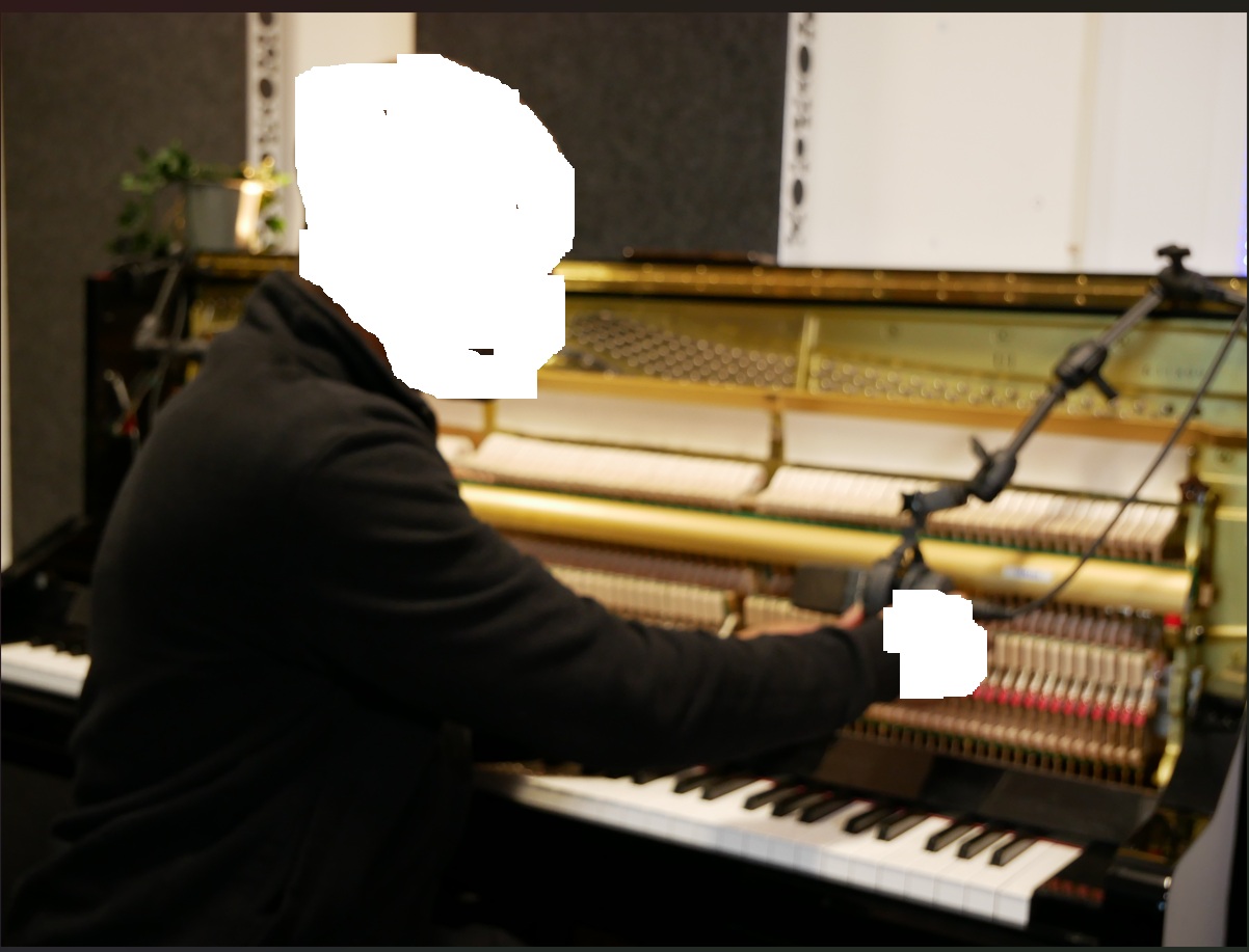 Studio photo at the piano and recording setup
